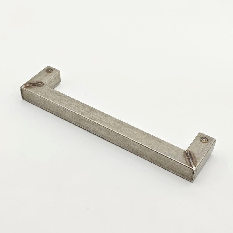 Close-up of brushed gold wall hook with screw fixing base